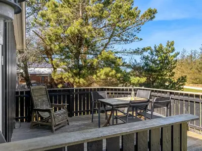 a patio with a table and chairs on a deck at Holiday Home Hellena - 700m from the sea by Interhome in Torsted