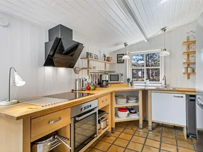 a kitchen with a wooden counter and a sink at Holiday Home Hellena - 700m from the sea by Interhome in Torsted