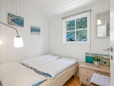 a white room with a bed and a window at Holiday Home Hellena - 700m from the sea by Interhome in Torsted