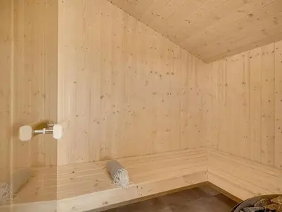 a wooden sauna with a tub in a room at Holiday Home Helga - 650m from the sea by Interhome in Torsted