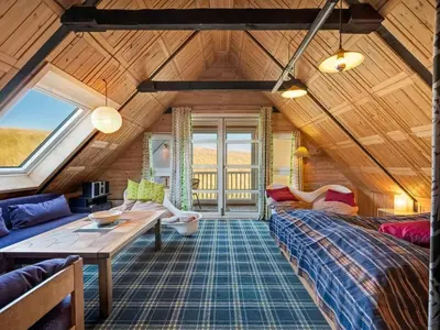 a living room with a couch and a table at Holiday Home Kurt - 75m from the sea by Interhome in Harboør