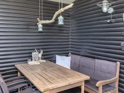 a dining room with a wooden table and chairs at 5 person holiday home in Roslev-By Traum in Roslev