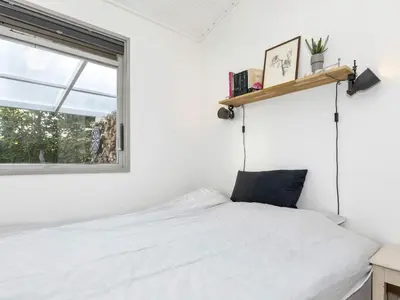 a bedroom with a white bed and a window at 5 person holiday home in Roslev-By Traum in Roslev