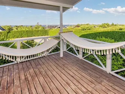 a porch with two hammocks on a deck at 5 person holiday home in Roslev-By Traum in Roslev