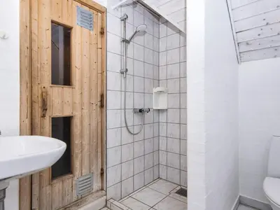 a bathroom with a shower with a toilet and a sink at 4 star holiday home in Harboøre in Harboør
