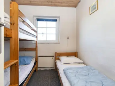 two bunk beds in a small room with a window at 4 star holiday home in Harboøre in Harboør