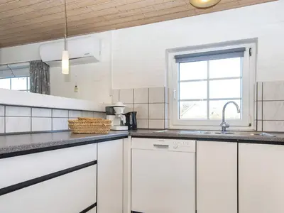 a kitchen with white cabinets and a window at 4 star holiday home in Harboøre in Harboør