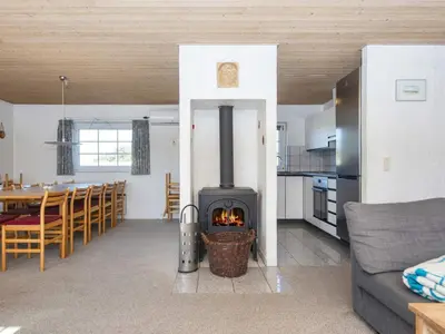 a living room with a wood stove in a kitchen at 4 star holiday home in Harboøre in Harboør