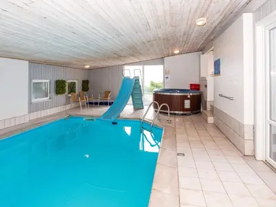 a swimming pool with a slide and a slide at Family Fun with Fjord View - By Traum Ferienwohnungen in Thyholm