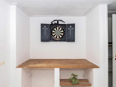 a dart board on a wall in a room at Family Fun with Fjord View - By Traum Ferienwohnungen in Thyholm