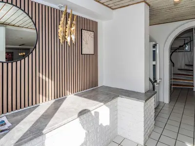 a lobby with a circular mirror and a staircase at Family Fun with Fjord View - By Traum Ferienwohnungen in Thyholm