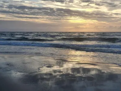a reflection of the sky in the water on the beach at 8 person holiday home in Pandrup-By Traum in Pandrup