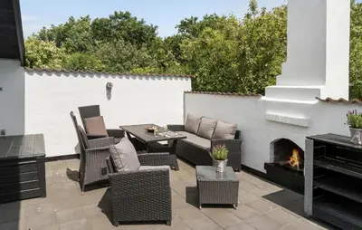 a patio with a couch and chairs and a fireplace at 3 Bedroom Awesome Home In Hurup Thy in Sønder Ydby