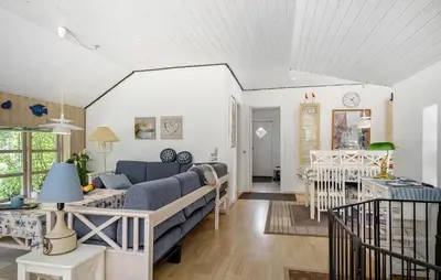 a living room with a couch and a table at 3 Bedroom Awesome Home In Hurup Thy in Sønder Ydby