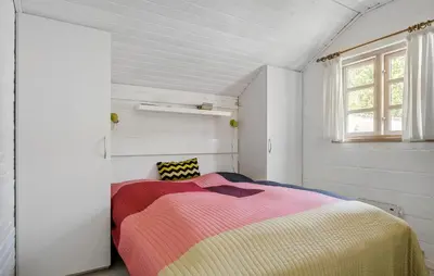 a bedroom with a bed with a colorful blanket at 3 Bedroom Awesome Home In Hurup Thy in Sønder Ydby