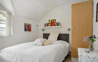 a bedroom with a white bed in a room at 3 Bedroom Awesome Home In Hurup Thy in Sønder Ydby