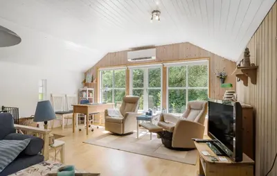 a living room with a couch and chairs and a tv at 3 Bedroom Awesome Home In Hurup Thy in Sønder Ydby