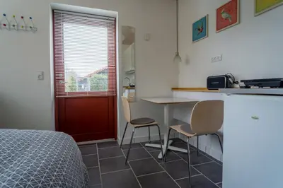 a kitchen with a table and chairs in a room at Hedelandets Camping in Sevel