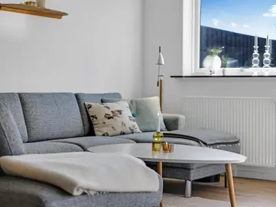 a living room with a couch and a coffee table at Holiday Home Sulo - 300m from the sea by Interhome in Blokhus