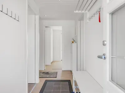 a hallway with white walls and a hallway with white doors at Holiday Home Sulo - 300m from the sea by Interhome in Blokhus