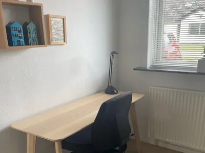 a wooden desk with a chair and a lamp on it at Holiday Home Sulo - 300m from the sea by Interhome in Blokhus
