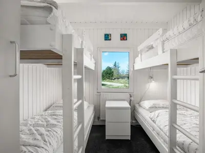 a bedroom with two bunk beds and a window at Holiday Home Annlisa - 1km from the sea by Interhome in Blokhus