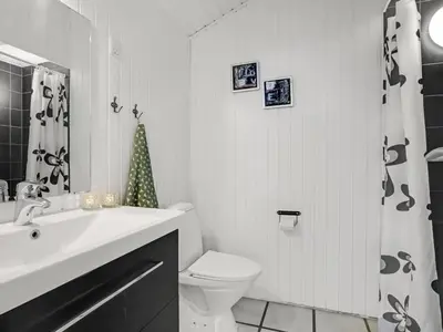 a white bathroom with a sink and a toilet at Holiday Home Annlisa - 1km from the sea by Interhome in Blokhus