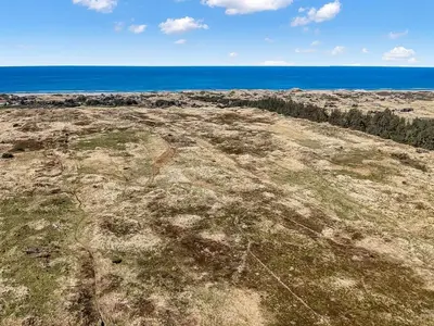 an empty field with the ocean in the background at Holiday Home Annlisa - 1km from the sea by Interhome in Blokhus