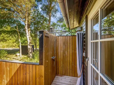 a wooden gate with a shower in a house at Holiday Home Jenvold - 1-5km from the sea by Interhome in Blokhus