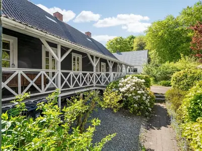 a house with a bridge in a garden at Holiday Home Ejnarine - 600m to the fjord by Interhome in Farsø