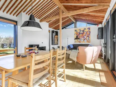 a kitchen and dining room with a table and chairs at Holiday Home Amarie - 1km from the sea by Interhome in Pandrup