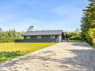 a house with a gravel driveway at Holiday Home Ema - 1-9km from the sea by Interhome in Saltum