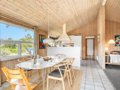 a kitchen and dining room with a table and chairs at Holiday Home Elisenda - 1km from the sea by Interhome in Torsted