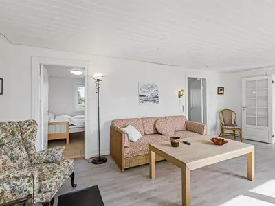 a living room with a couch and a coffee table at Holiday Home Kerrin - 1km from the sea by Interhome in Hanstholm