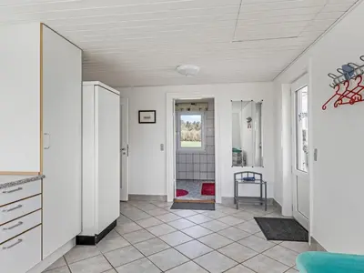 a hallway with white walls and a tile floor at Holiday Home Kerrin - 1km from the sea by Interhome in Hanstholm