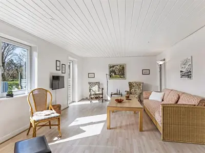 a living room with a couch and a table at Holiday Home Kerrin - 1km from the sea by Interhome in Hanstholm