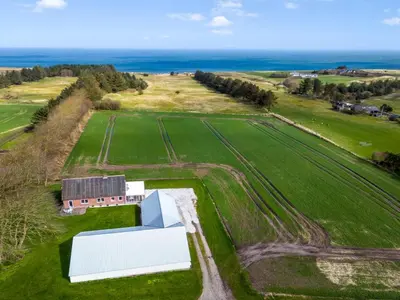 an aerial view of a farm with a white building at Holiday Home Kerrin - 1km from the sea by Interhome in Hanstholm