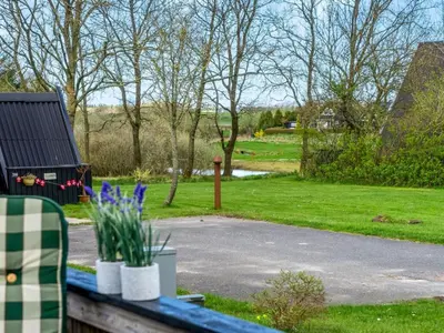 a view of a yard with a bench and grass at Holiday Home Erly - 18km to the fjord by Interhome in Farsø
