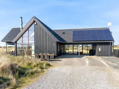 a house with solar panels on the side of it at Holiday Home Lilie - 350m from the sea by Interhome in Saltum