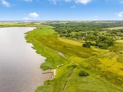 an aerial view of the shoreline of a lake at Holiday Home Skip - 300m to the fjord by Interhome in Højslev