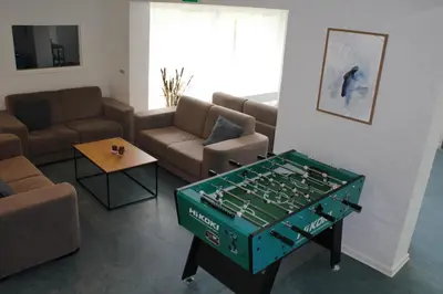 a living room with a foosball table in the middle at Hotel Traneparken in Nykøbing Mors