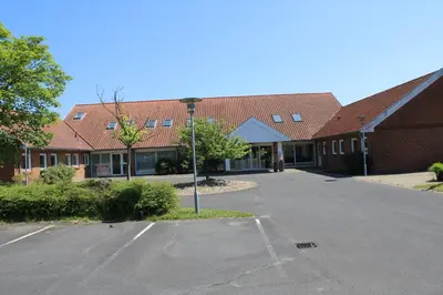 an empty parking lot in front of a building at Hotel Traneparken in Nykøbing Mors