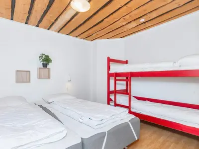 two beds in a room with a red bunk bed at 8 person holiday home in Hurup Thy-By Traum in Sindrup