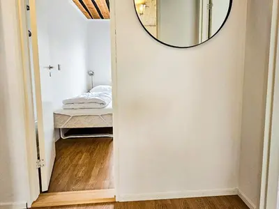 a mirror on a wall in a room with a bed at 8 person holiday home in Hurup Thy-By Traum in Sindrup