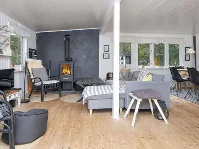 a living room with a bed and a fireplace at 5 person holiday home in Thyholm-By Traum in Thyholm