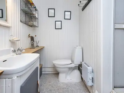 a bathroom with a white toilet and a sink at 5 person holiday home in Thyholm-By Traum in Thyholm