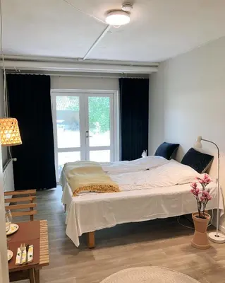 a bedroom with a large bed and a window at Skovly in Viborg