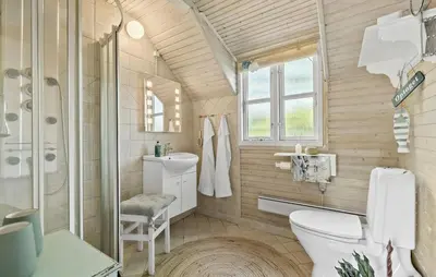 a bathroom with a toilet and a shower and a sink at 2 Bedroom Beautiful Home In Farsø in Farsø