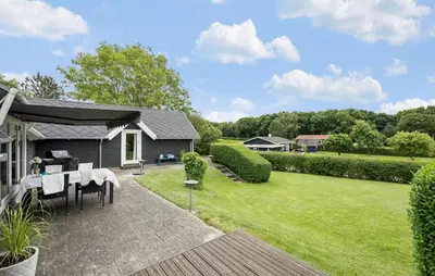 a backyard with a table and a lawn at 2 Bedroom Beautiful Home In Farsø in Farsø