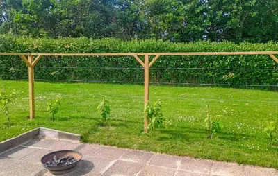 a garden with a wooden fence and a potted plant at 3 Bedroom Cozy Home In Vinderup in Vinderup